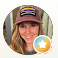 photo of person smiling and wearing a hat