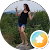 image of person posing with greenery in the background.